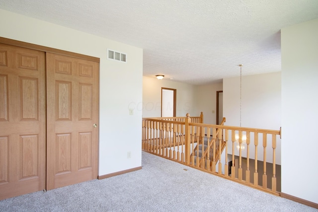 237 Harvard Loop, Delaware, OH 43015 - corridor with carpet flooring, an upstairs landing, and a textured ceiling