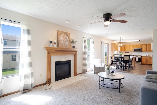 237 Harvard Loop, Delaware, OH 43015 - living area featuring a fireplace with flush hearth, a textured ceiling, a ceiling fan, light colored carpet, and recessed lighting