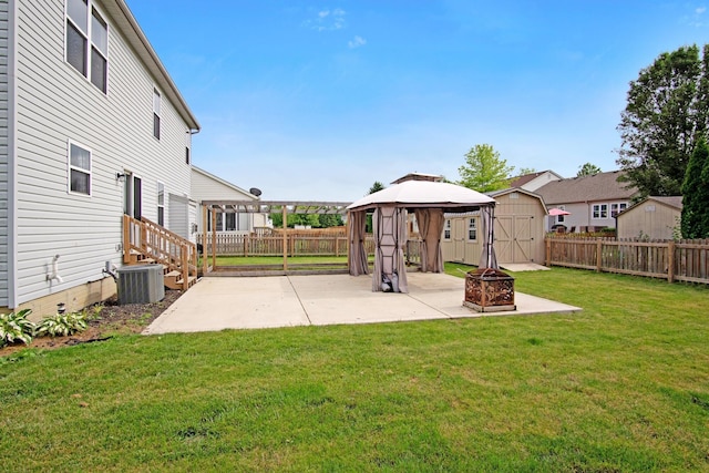 237 Harvard Loop, Delaware, OH 43015 - fenced backyard featuring a patio, an outdoor fire pit, a gazebo, and a shed
