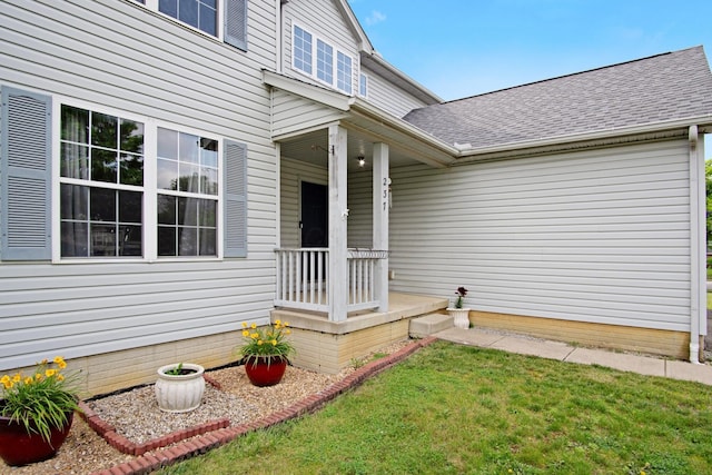 237 Harvard Loop, Delaware, OH 43015 - property entrance with a yard, a shingled roof, and a porch