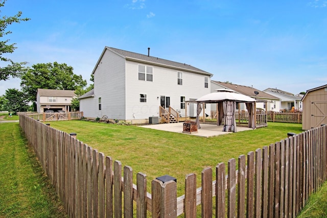 237 Harvard Loop, Delaware, OH 43015 - rear view of property featuring a gazebo, a patio area, a fenced backyard, a storage unit, and an outdoor fire pit