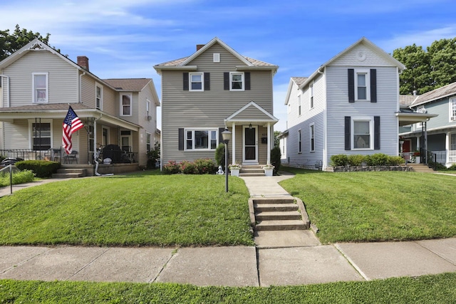 625 E Mulberry St, Lancaster, OH 43130 - traditional-style home with a porch, a front yard, and a chimney