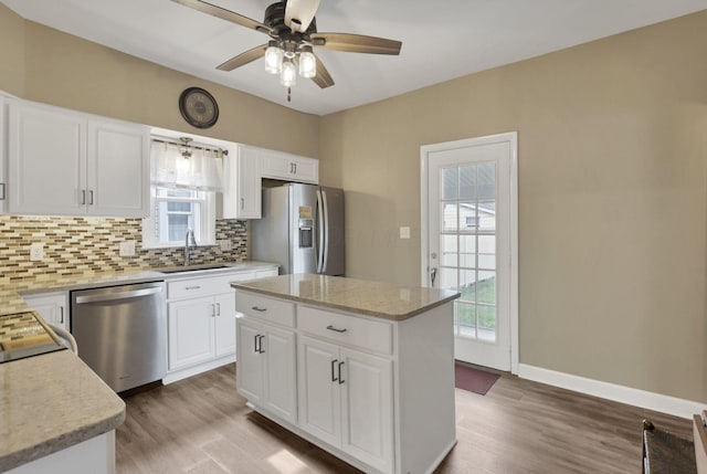 625 E Mulberry St, Lancaster, OH 43130 - kitchen with appliances with stainless steel finishes, backsplash, light wood-style flooring, and ceiling fan