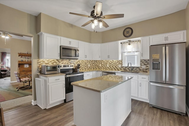 625 E Mulberry St, Lancaster, OH 43130 - kitchen with stainless steel appliances, a ceiling fan, backsplash, white cabinetry, and dark wood-style flooring