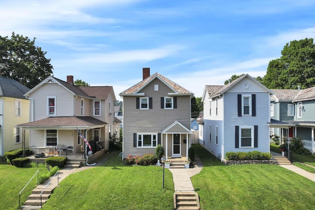625 E Mulberry St, Lancaster, OH 43130 - view of front facade with a front yard, a residential view, and a chimney