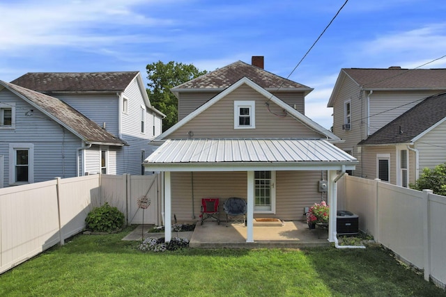 625 E Mulberry St, Lancaster, OH 43130 - back of property featuring a metal roof, a fenced backyard, and a patio