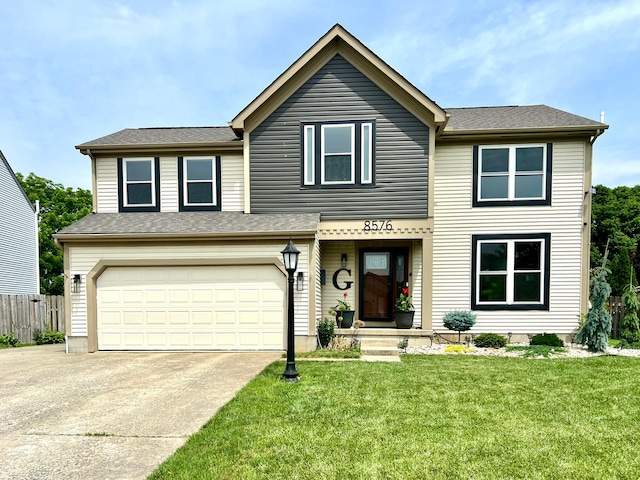 8576 Army Pl, Galloway, OH 43119 - traditional-style house featuring concrete driveway, an attached garage, and a shingled roof