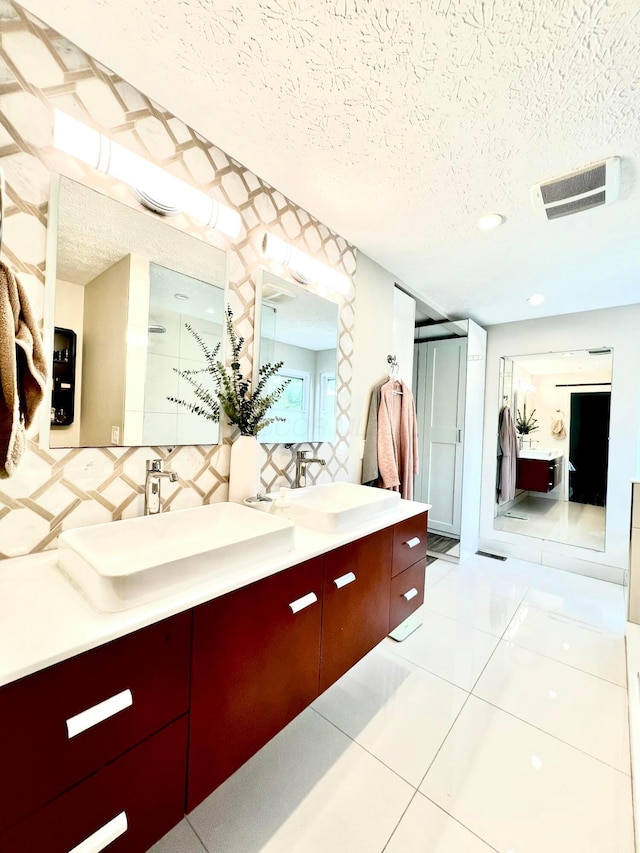 8576 Army Pl, Galloway, OH 43119 - full bath featuring a textured ceiling, double vanity, tile patterned flooring, a stall shower, and water heater