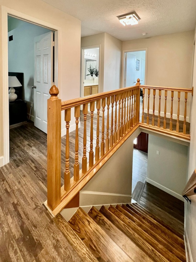 8576 Army Pl, Galloway, OH 43119 - stairway with wood finished floors and a textured ceiling