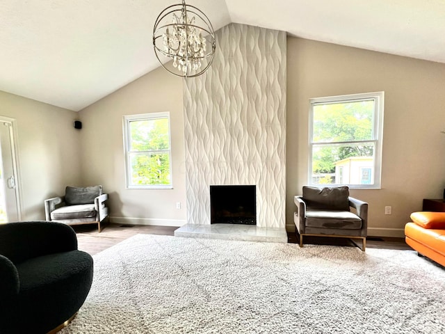 8576 Army Pl, Galloway, OH 43119 - living area with lofted ceiling, wood finished floors, a chandelier, and a premium fireplace