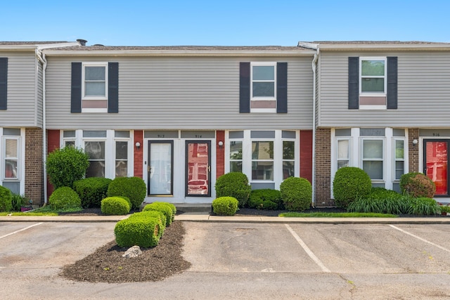 914 Worthington Woods Blvd Unit 11, Columbus, OH 43085 - view of property with uncovered parking and brick siding