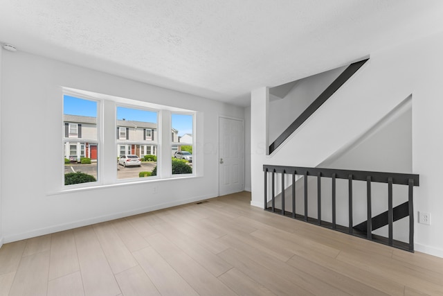 914 Worthington Woods Blvd Unit 11, Columbus, OH 43085 - spare room featuring wood finished floors and a textured ceiling