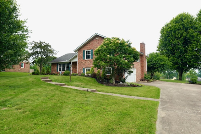 249 Orchard View Dr NE, Lancaster, OH 43130 - view of front of home featuring brick siding, driveway, a front lawn, and a chimney
