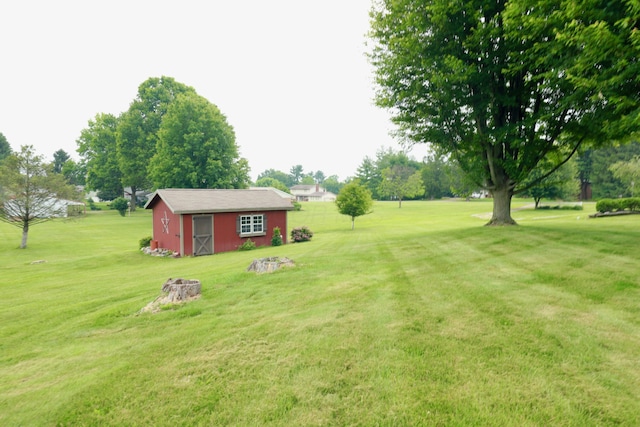 249 Orchard View Dr NE, Lancaster, OH 43130 - view of green lawn with an outbuilding and a fire pit