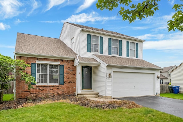 5684 Duchess Ct, Galloway, OH 43119 - traditional-style house with an attached garage, asphalt driveway, brick siding, and a shingled roof