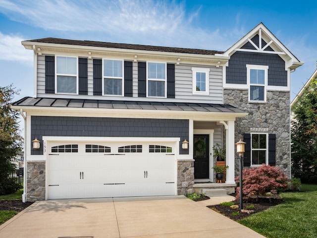 153 Shawnee Dr, Pickerington, OH 43147 - craftsman house with stone siding, a standing seam roof, driveway, and a garage