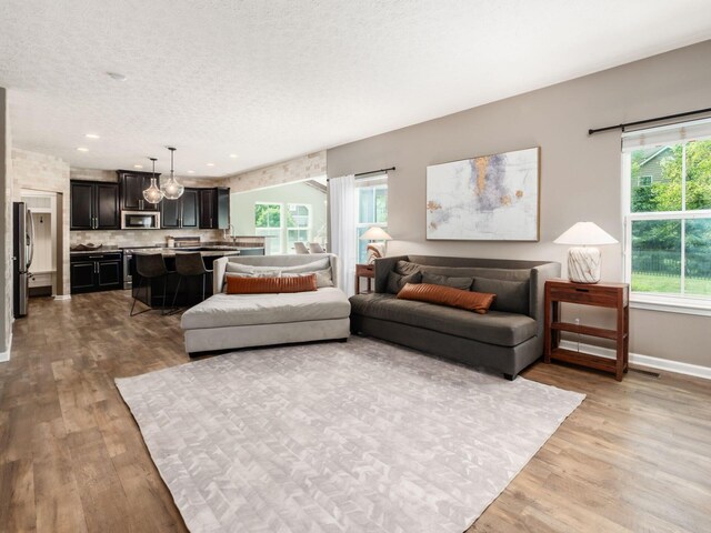 153 Shawnee Dr, Pickerington, OH 43147 - living area featuring light wood-type flooring, a textured ceiling, and recessed lighting