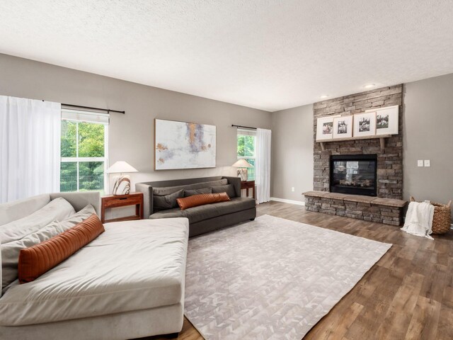 153 Shawnee Dr, Pickerington, OH 43147 - living room featuring a textured ceiling, wood finished floors, a stone fireplace, and recessed lighting