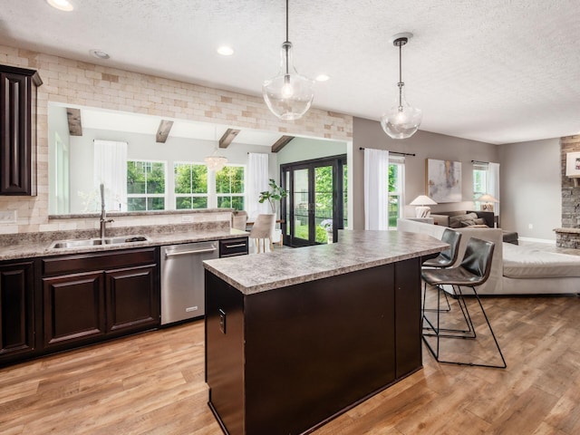 153 Shawnee Dr, Pickerington, OH 43147 - kitchen with dishwasher, open floor plan, a textured ceiling, lofted ceiling, and light countertops
