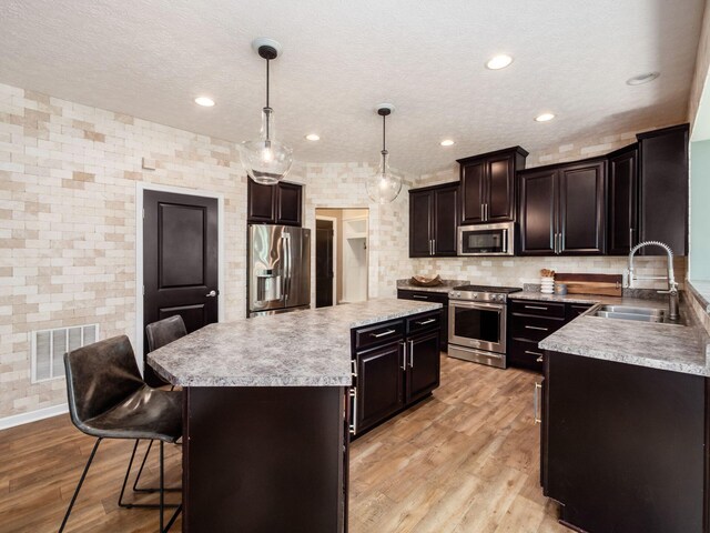 153 Shawnee Dr, Pickerington, OH 43147 - kitchen with stainless steel appliances, a center island, light countertops, a kitchen breakfast bar, and decorative backsplash
