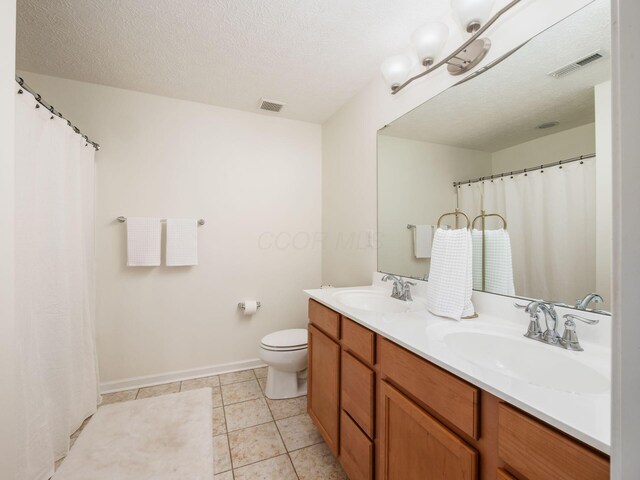 153 Shawnee Dr, Pickerington, OH 43147 - bathroom featuring double vanity, a textured ceiling, and tile patterned flooring