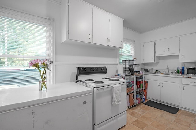 1265 Duxberry Ave, Columbus, OH 43211 - kitchen featuring white electric range oven, white cabinetry, light countertops, and ornamental molding