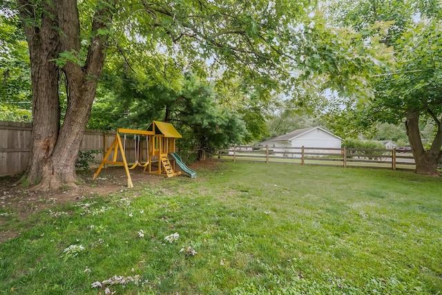 11 Richards Dr, Delaware, OH 43015 - fenced backyard featuring a playground