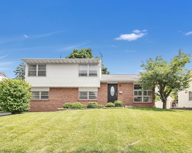 1121 Afton Rd, Columbus, OH 43221 - tri-level home with brick siding and a front lawn