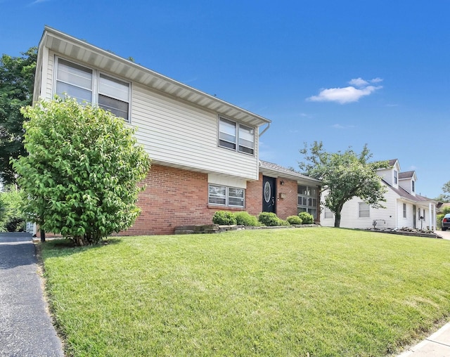 1121 Afton Rd, Columbus, OH 43221 - tri-level home featuring brick siding and a front yard