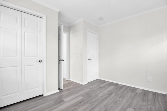 1121 Afton Rd, Columbus, OH 43221 - unfurnished bedroom featuring wood finished floors, crown molding, and a closet