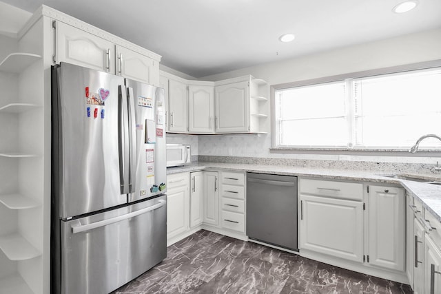 1121 Afton Rd, Columbus, OH 43221 - kitchen with stainless steel appliances, open shelves, white cabinetry, light stone countertops, and recessed lighting