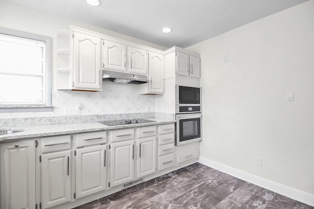 1121 Afton Rd, Columbus, OH 43221 - kitchen with black appliances, under cabinet range hood, white cabinetry, light stone countertops, and dark marble finish flooring