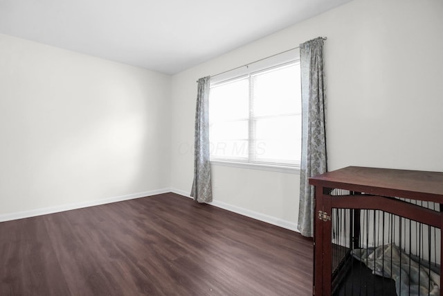 1121 Afton Rd, Columbus, OH 43221 - unfurnished bedroom featuring dark wood-style flooring and baseboards