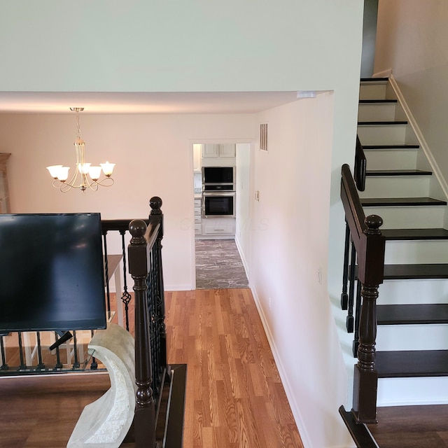 1121 Afton Rd, Columbus, OH 43221 - interior space featuring light wood-style floors, a chandelier, and stairway