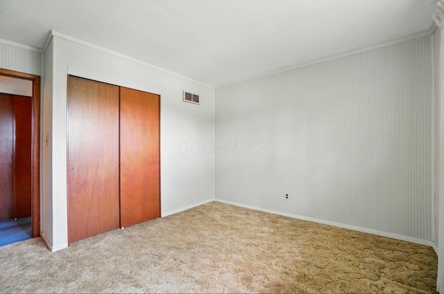 4985 N Lake Hill Dr, Delaware, OH 43015 - unfurnished bedroom featuring crown molding, carpet floors, and a closet