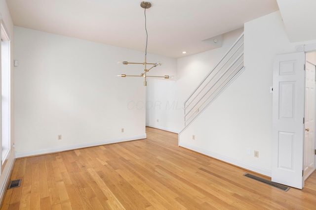 318 Berger Aly, Columbus, OH 43206 - unfurnished room featuring a chandelier and light wood-type flooring