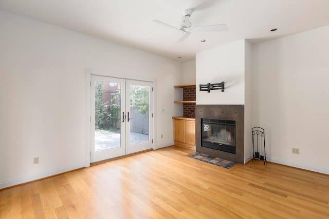 318 Berger Aly, Columbus, OH 43206 - unfurnished living room featuring light wood finished floors, french doors, ceiling fan, and a tiled fireplace