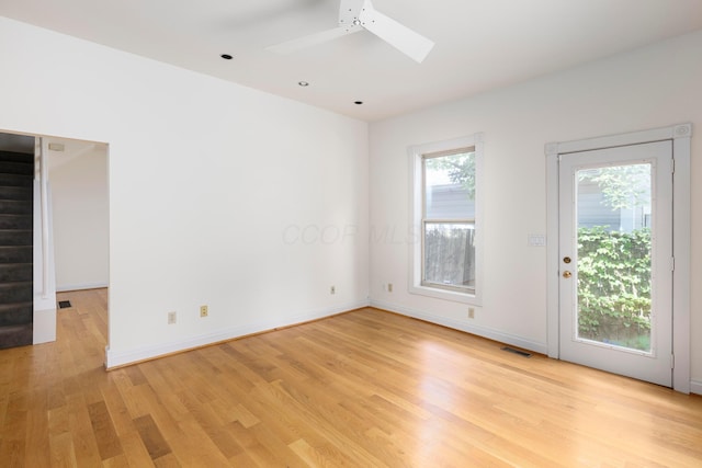318 Berger Aly, Columbus, OH 43206 - spare room with a skylight, light wood-type flooring, stairs, and ceiling fan