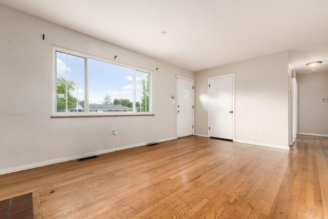 1208 Carolwood Ave, Columbus, OH 43227 - unfurnished living room with light wood-style floors and baseboards