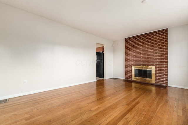 1208 Carolwood Ave, Columbus, OH 43227 - unfurnished living room with a brick fireplace and wood-type flooring