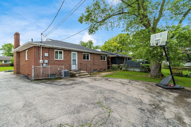 1208 Carolwood Ave, Columbus, OH 43227 - rear view of property featuring brick siding and a chimney