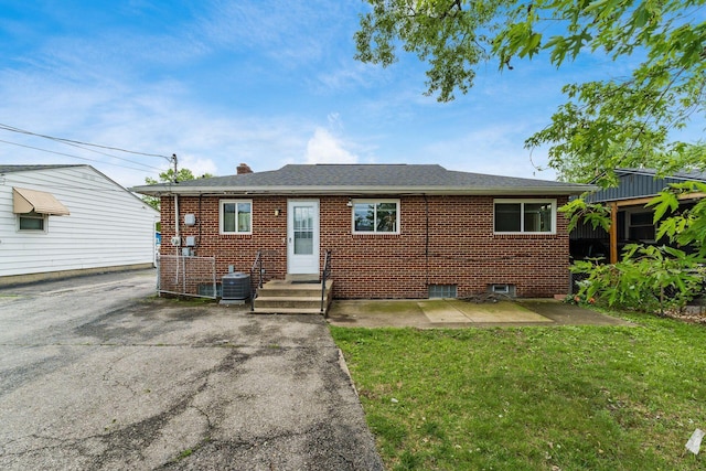 1208 Carolwood Ave, Columbus, OH 43227 - view of front facade with brick siding, a front lawn, and a chimney