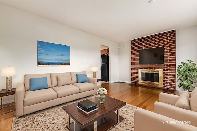 1208 Carolwood Ave, Columbus, OH 43227 - living area with wood finished floors and a brick fireplace