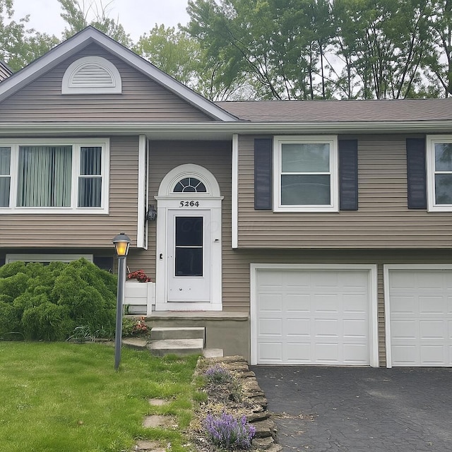 5264 Davidson Rd, Hilliard, OH 43026 - split foyer home with a garage, asphalt driveway, and a front lawn