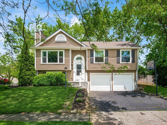 5264 Davidson Rd, Hilliard, OH 43026 - raised ranch featuring a garage, a chimney, and asphalt driveway