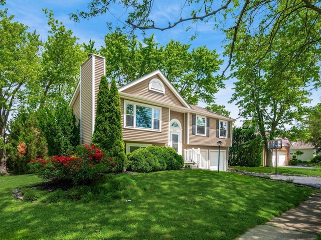 5264 Davidson Rd, Hilliard, OH 43026 - split foyer home with a chimney, an attached garage, and a front lawn