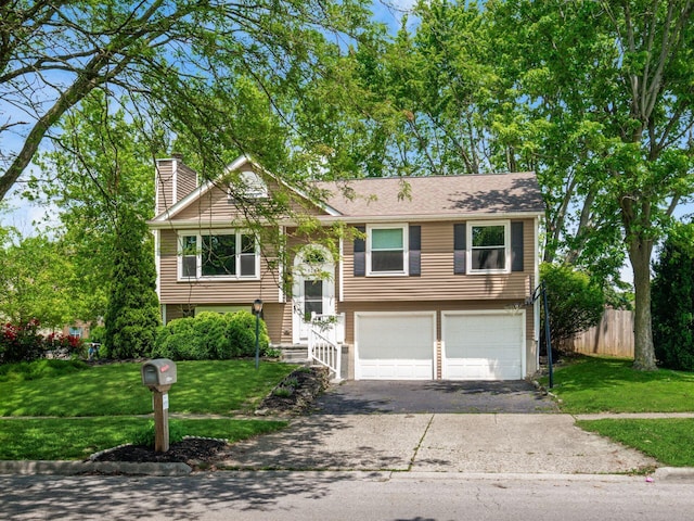 5264 Davidson Rd, Hilliard, OH 43026 - bi-level home featuring a chimney, an attached garage, and asphalt driveway