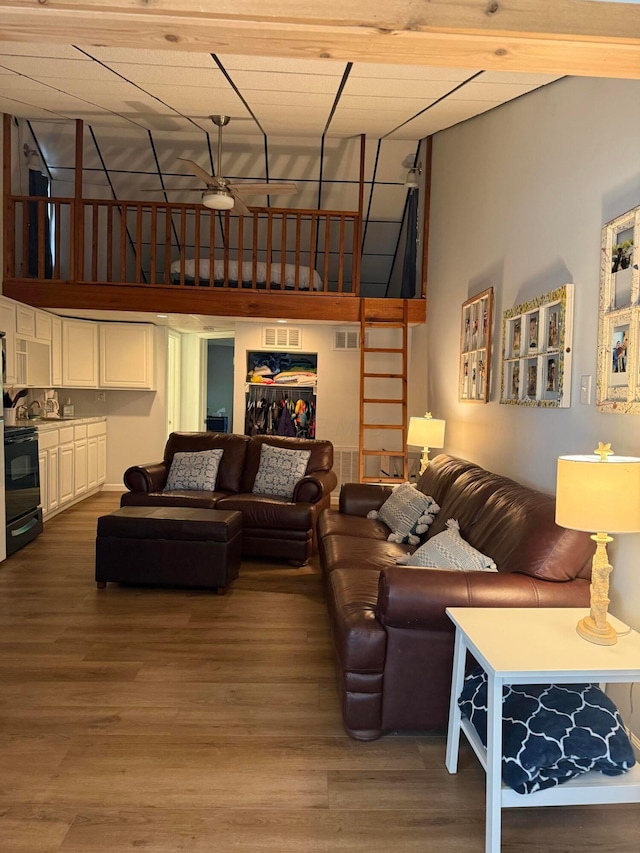 13997 Custers Point Rd NE, Thornville, OH 43076 - living room featuring a ceiling fan, a high ceiling, and wood finished floors