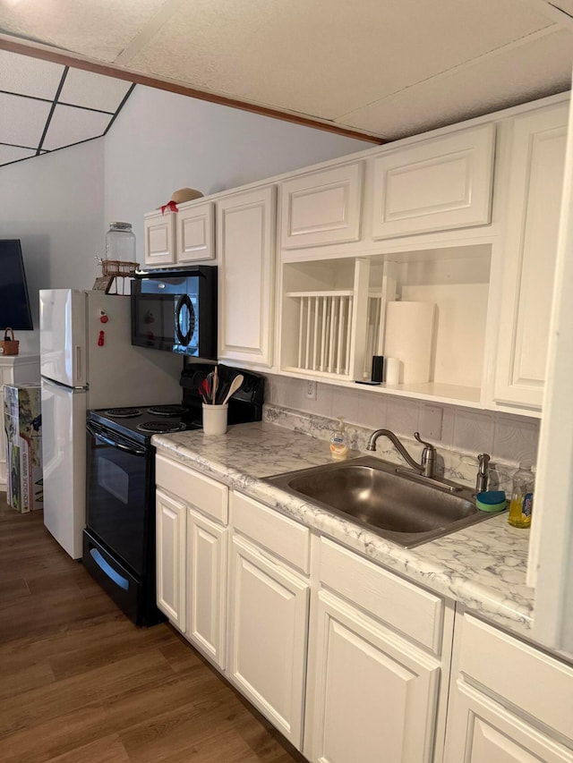 13997 Custers Point Rd NE, Thornville, OH 43076 - kitchen with black appliances, dark wood-type flooring, light countertops, white cabinets, and a drop ceiling