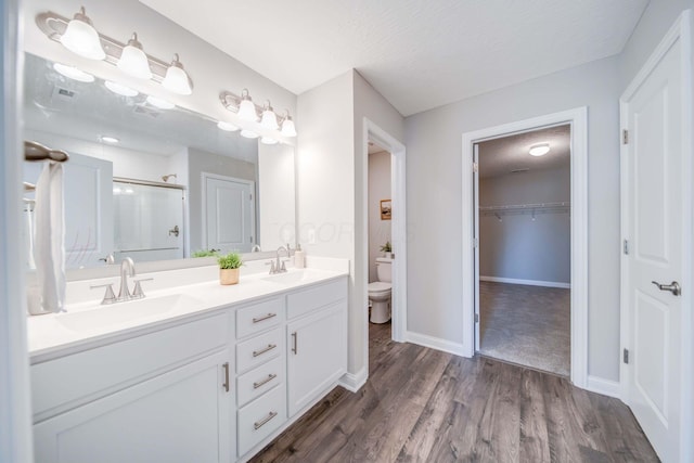 66 Genoa Cir, Commercial Point, OH 43116 - full bathroom featuring a shower stall, double vanity, wood finished floors, and a spacious closet